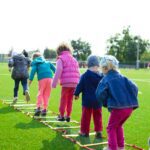 children s team building on green grassland