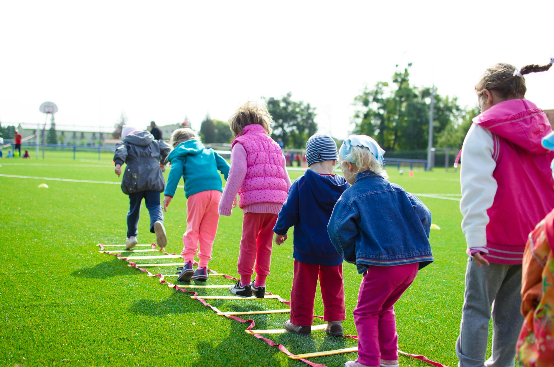 children s team building on green grassland